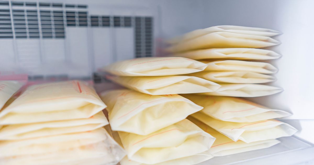 frozen breast milk in storage bags in freezer